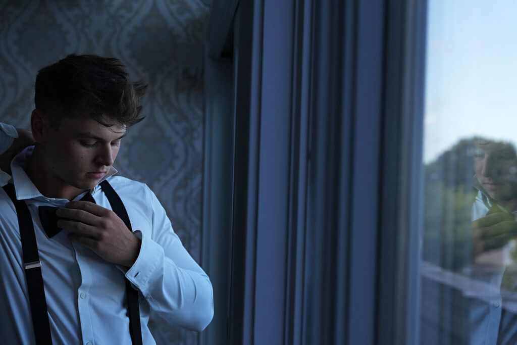 Stylish groom portraits while getting ready at Giorgio’s on Long Island, candid wedding photograp