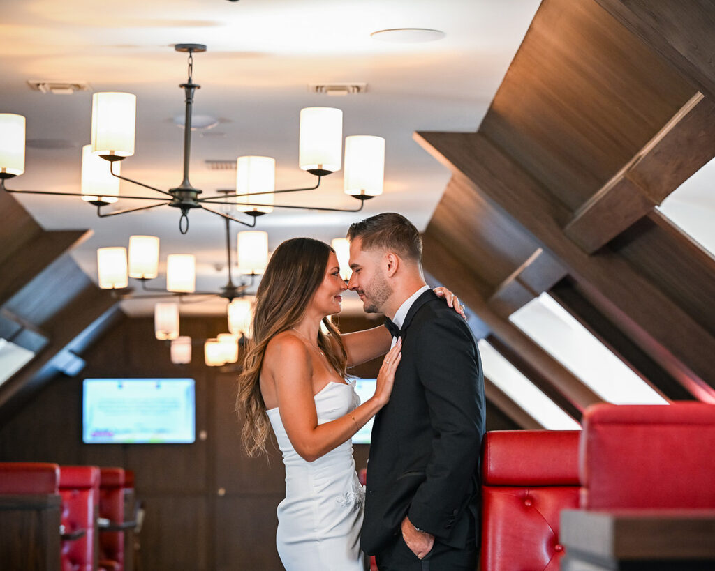 Engagement photo of a couple dancing by a piano at The Lannin in Eisenhower Park.