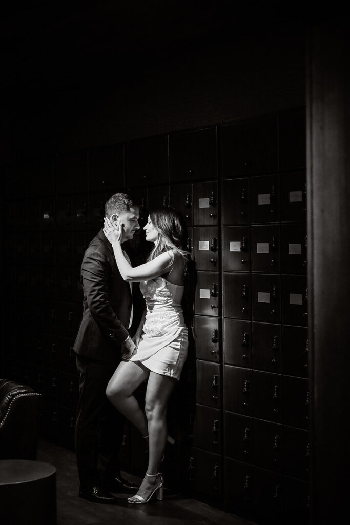 Glamorous engagement portrait in The Lannin cigar bar in Eisenhower Park, moody luxury setting.