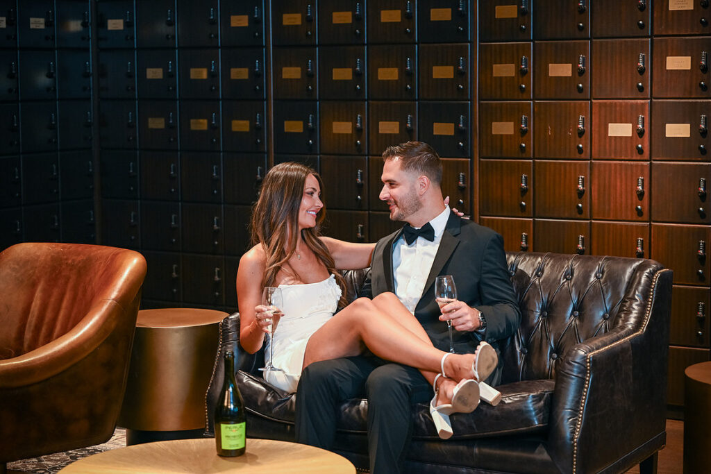 Bride and groom hanging out during a luxury engagement session at The Lannin in Eisenhower Park.