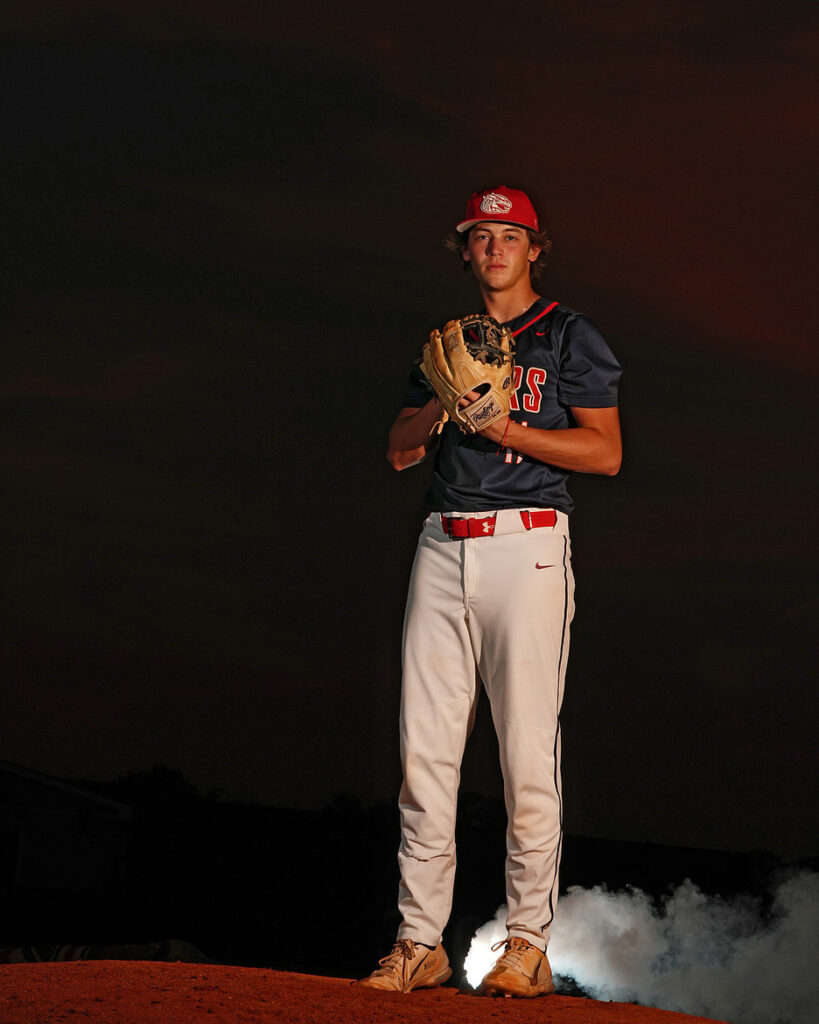 themed senior photography studio baseball senior full-body portrait with uniform