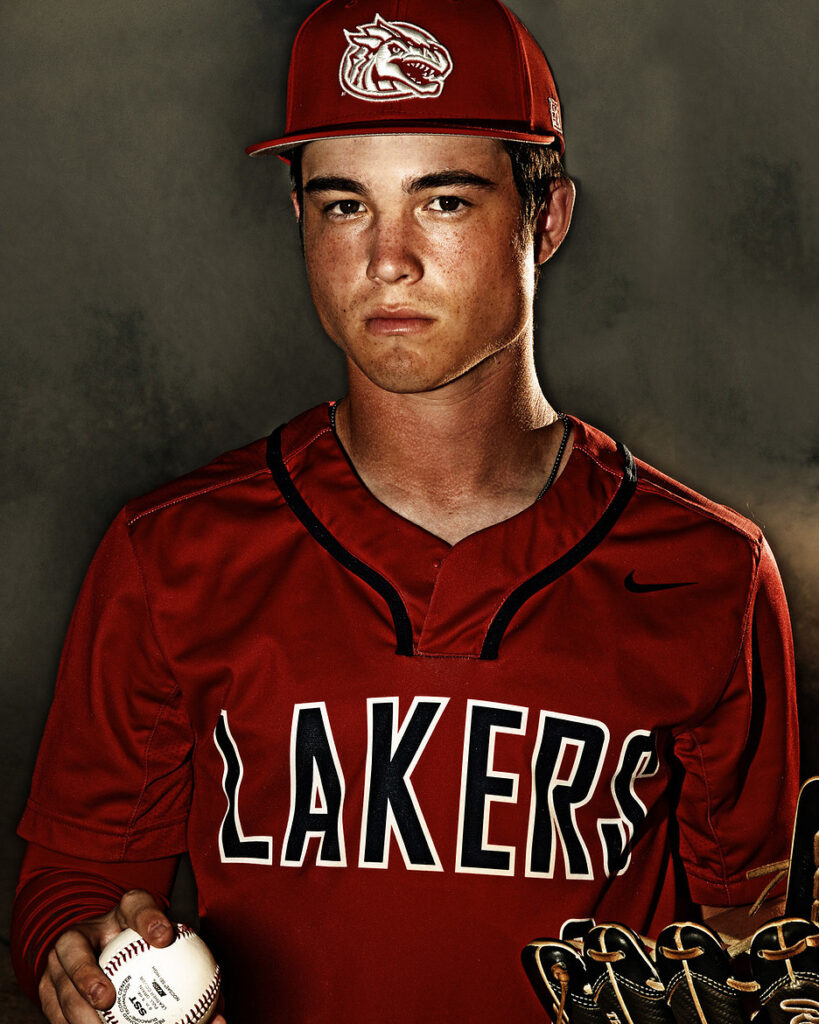 themed senior photography studio baseball senior portrait in red uniform close-up