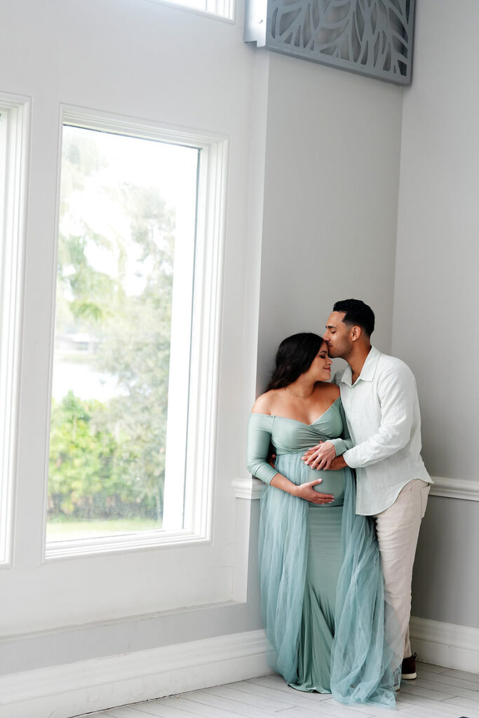 maternity photography couple portrait by window light indoors Leu Gardens