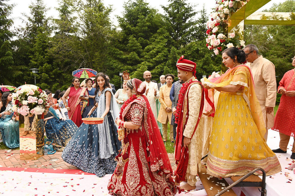 Hindu wedding ceremony baraat procession outdoor celebration with guests in colorful attire