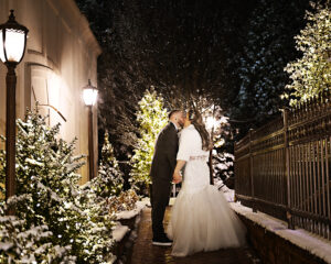 Bride and groom kissing in the snow at Crest Hollow Country Club on Long Island, photographed by Patken Photographer