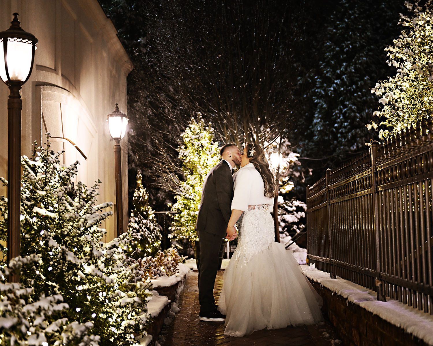 Bride and groom kissing in the snow at Crest Hollow Country Club on Long Island, photographed by Patken Photographer