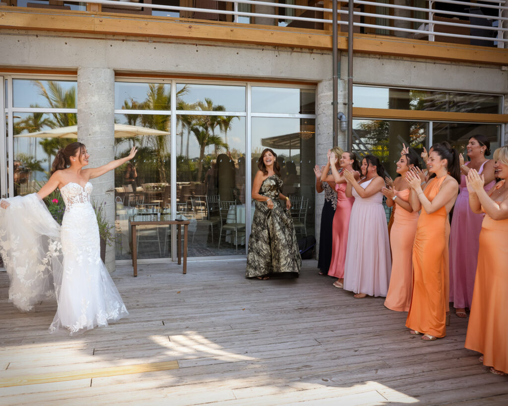 Bridesmaids first reveal lined up reacting as bride approaches on deck at Crescent Beach Club wedding Long Island New York