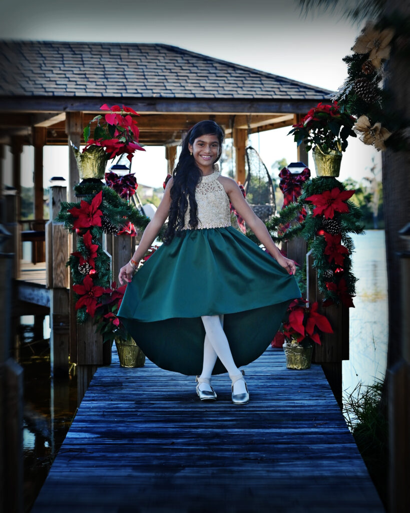 Holiday portrait of a toddler girl captured at a photography studio in Windermere, FL. featuring seasonal décor and soft studio lighting.