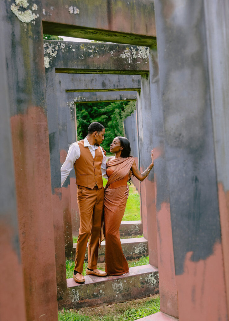 African American couple during a Brooklyn Botanic Garden engagement session walking through summer flowers
