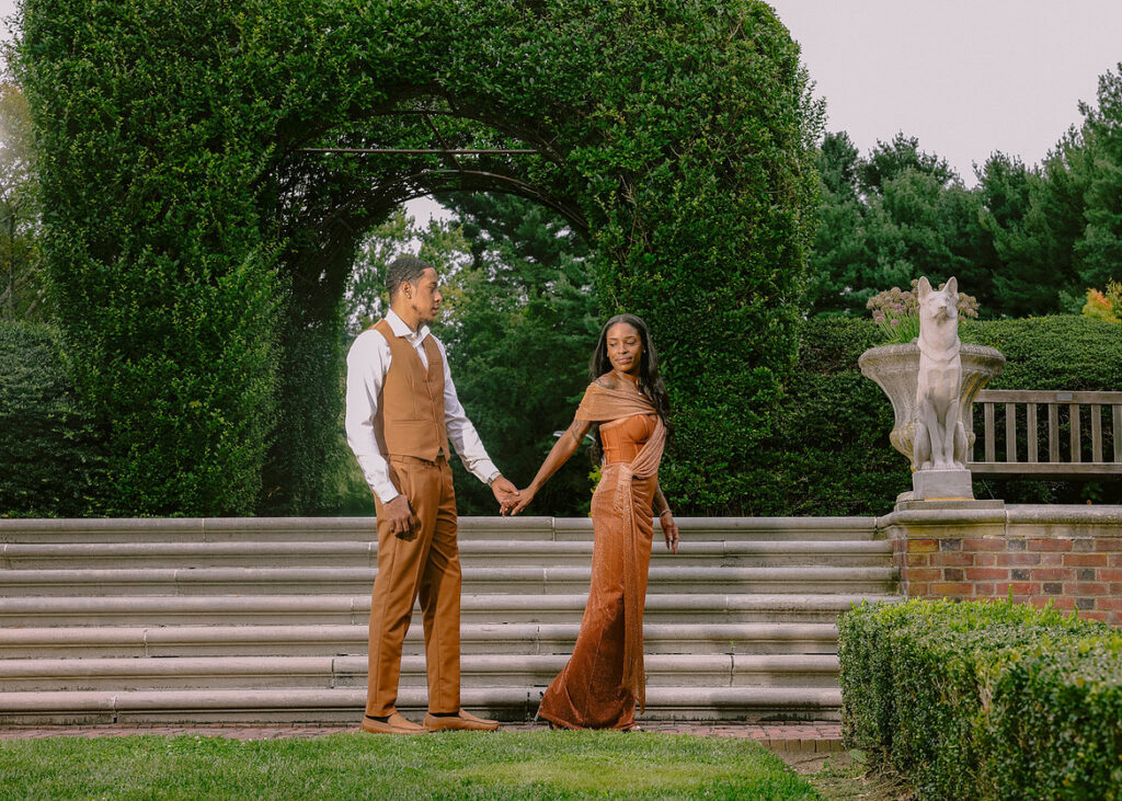 African American couple embracing during golden hour at Brooklyn Botanic Garden engagement session