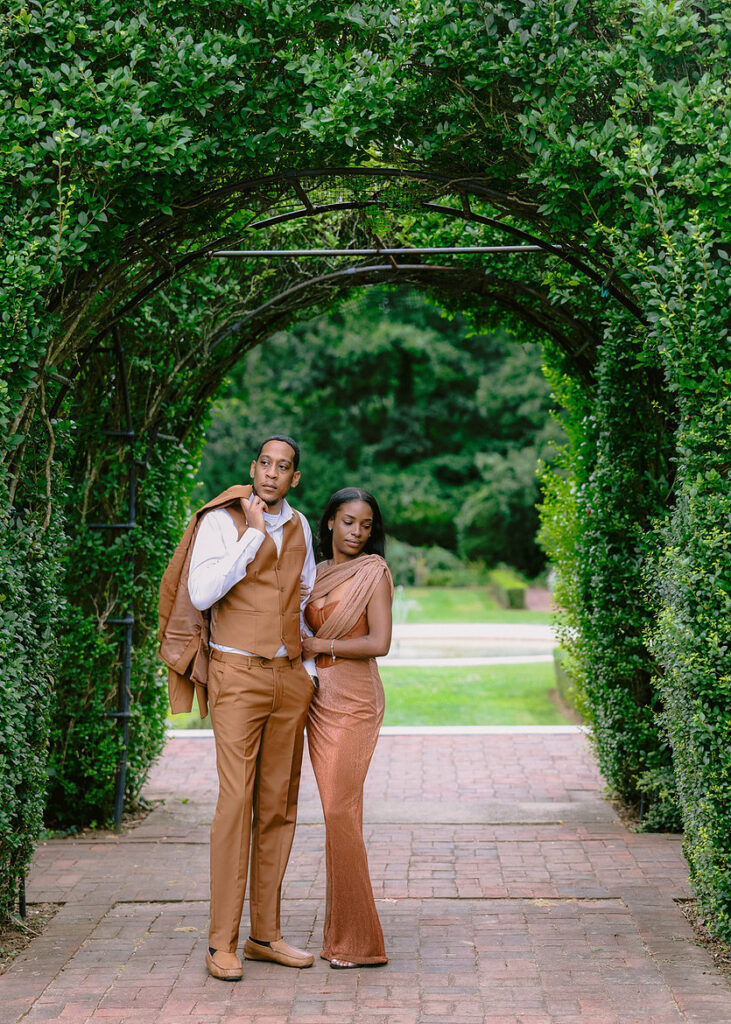 Candid engagement photo of an African American couple laughing at Brooklyn Botanic Garden in Brooklyn NY