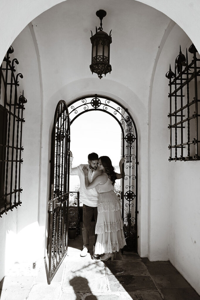 Engaged couple photographed during an engagement session at the Vanderbilt Museum on Long Island