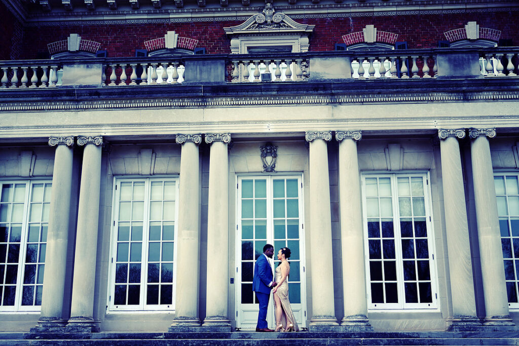 Engagement photo of a couple in front of the Old Westbury Gardens mansion on Long Island