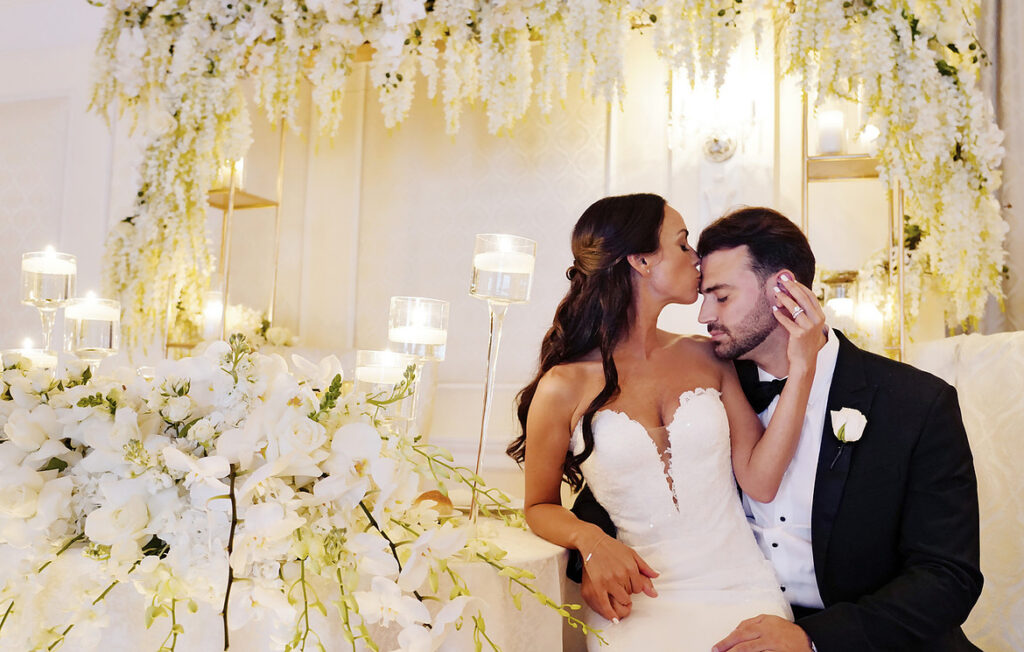storytelling wedding photography couple kissing with floral backdrop