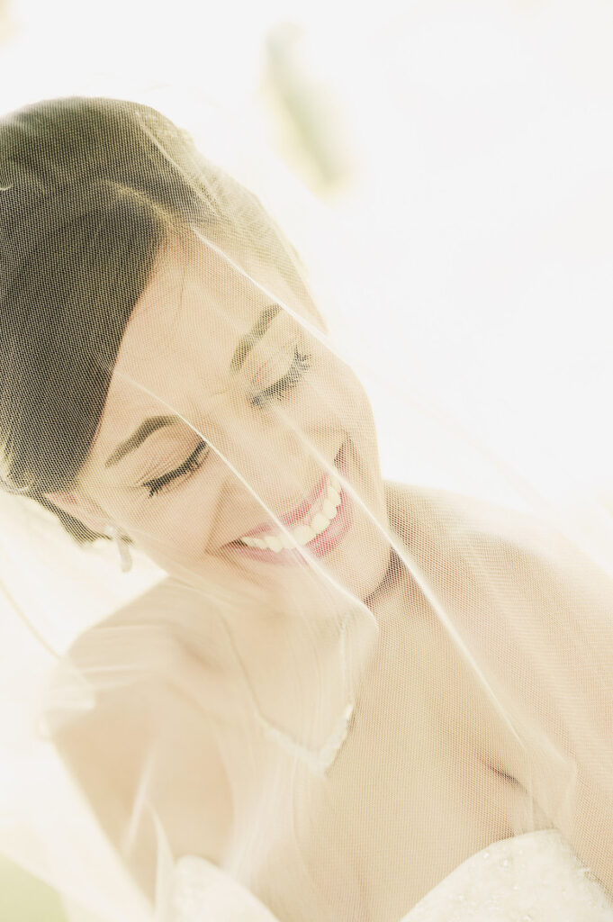 storytelling wedding photography of bride portrait behind veil with soft natural light