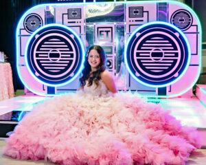 Bat Mitzvah portrait in front of the DJ booth and custom décor at The Standard at North Shore Synagogue in Syosset, NY