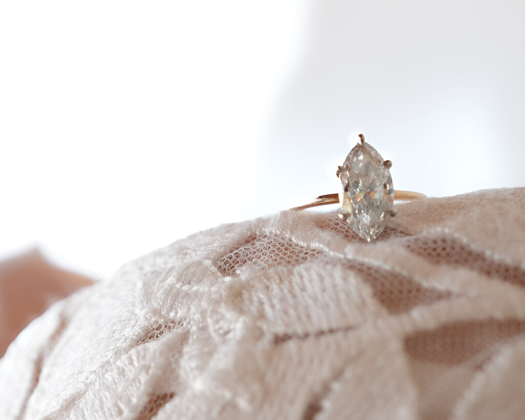 Close-up of engagement ring on wedding dress fabric at Crescent Beach Club wedding Long Island New York