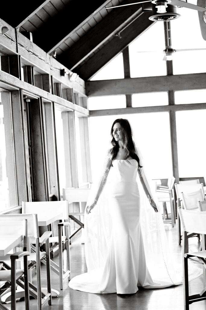 Black and white bride portrait under wooden beams at Crescent Beach Club Long Island New York
