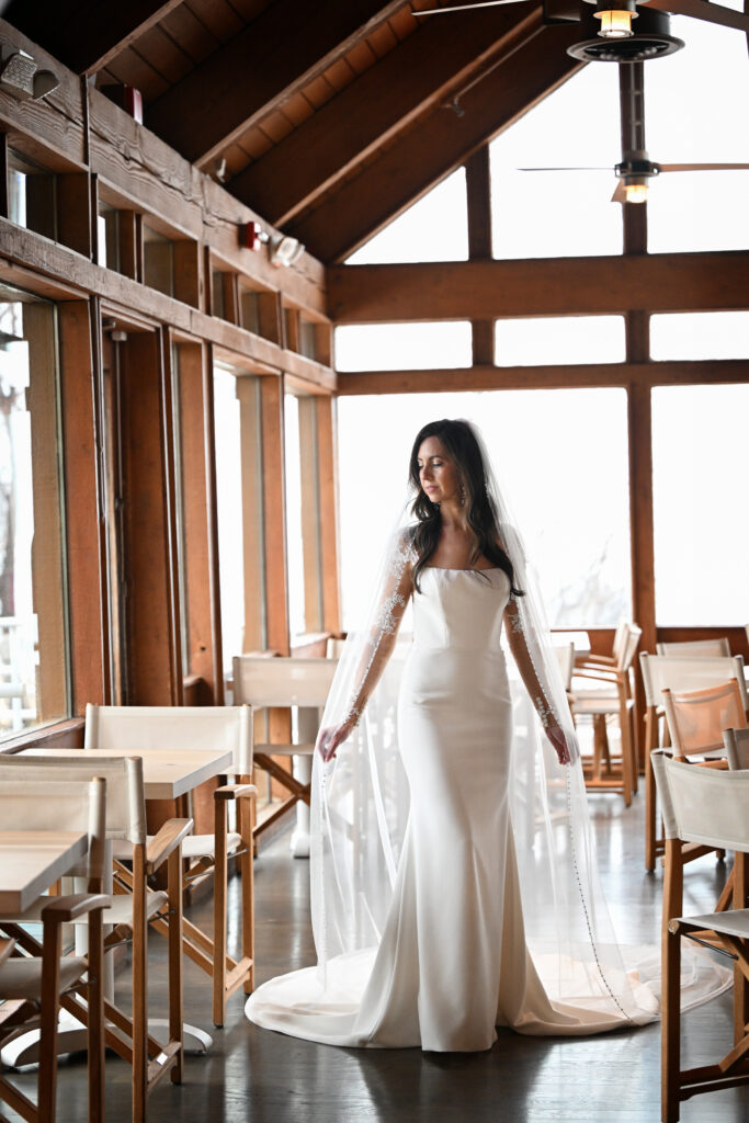 Bride standing under wooden beams at Crescent Beach Club wedding venue Long Island New York