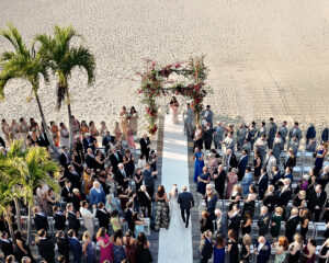 Aerial view of beach wedding ceremony with guests and floral arch at Crescent Beach Club Long Island New York
