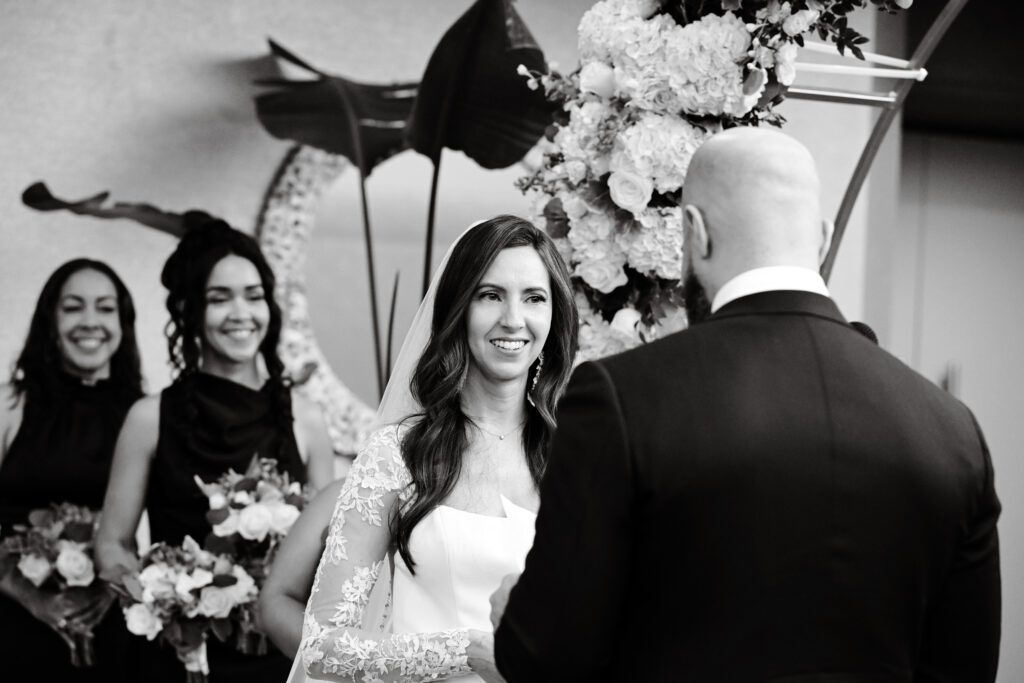 Black and white photo of bride smiling during ceremony at Crescent Beach Club Long Island New York