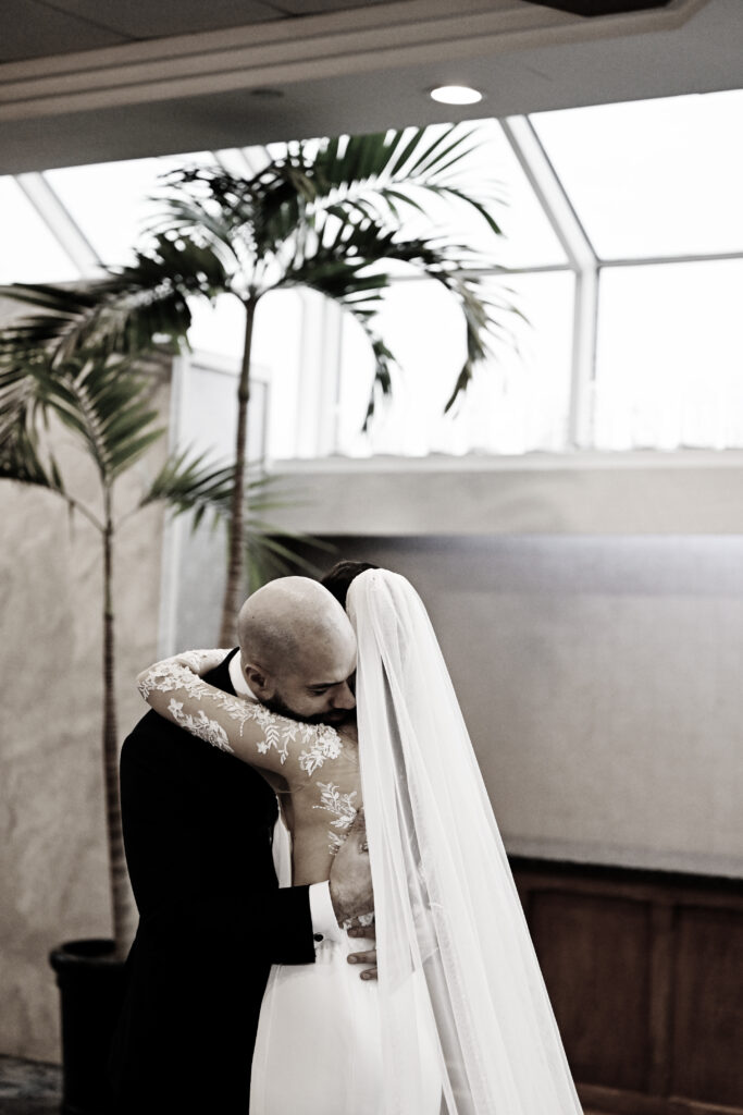 Black and white portrait of bride and groom kissing with veil at Crescent Beach Club Long Island New York