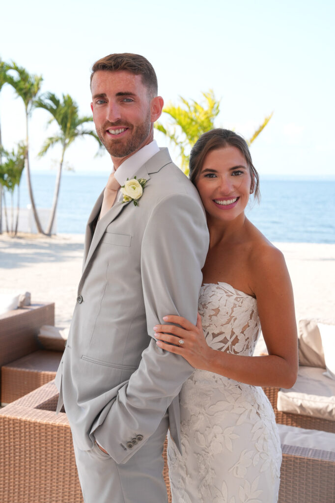 Bride and groom smiling together with ocean background at Crescent Beach Club Long Island New York wedding