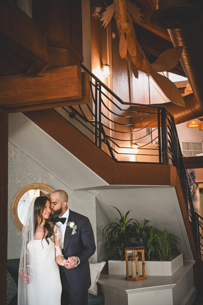 Bride and groom portrait on staircase at Crescent Beach Club wedding Long Island New York
