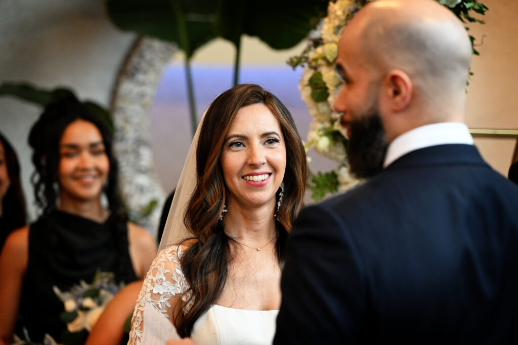 Bride smiling during wedding ceremony at Crescent Beach Club Long Island New York