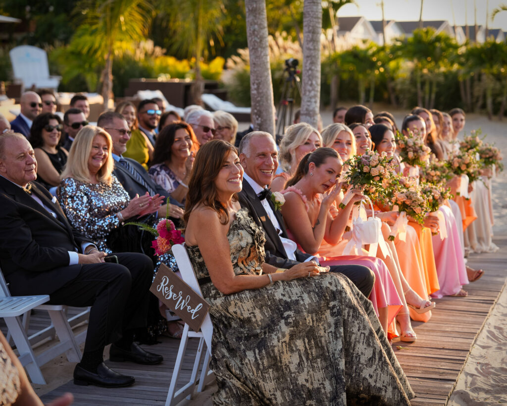 Wedding ceremony guests seated and watching on the beach at Crescent Beach Club Long Island New York