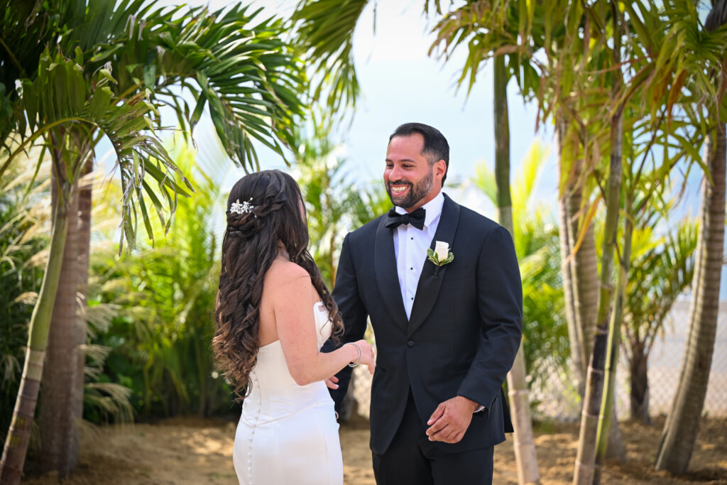 Bride and groom portrait with palm trees at Crescent Beach Club wedding on Long Island, New York.