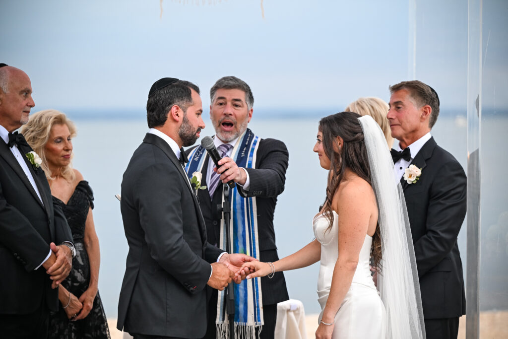 Jewish Wedding ceremony exchange at Crescent Beach Club on Long Island, New York with officiant and couple.