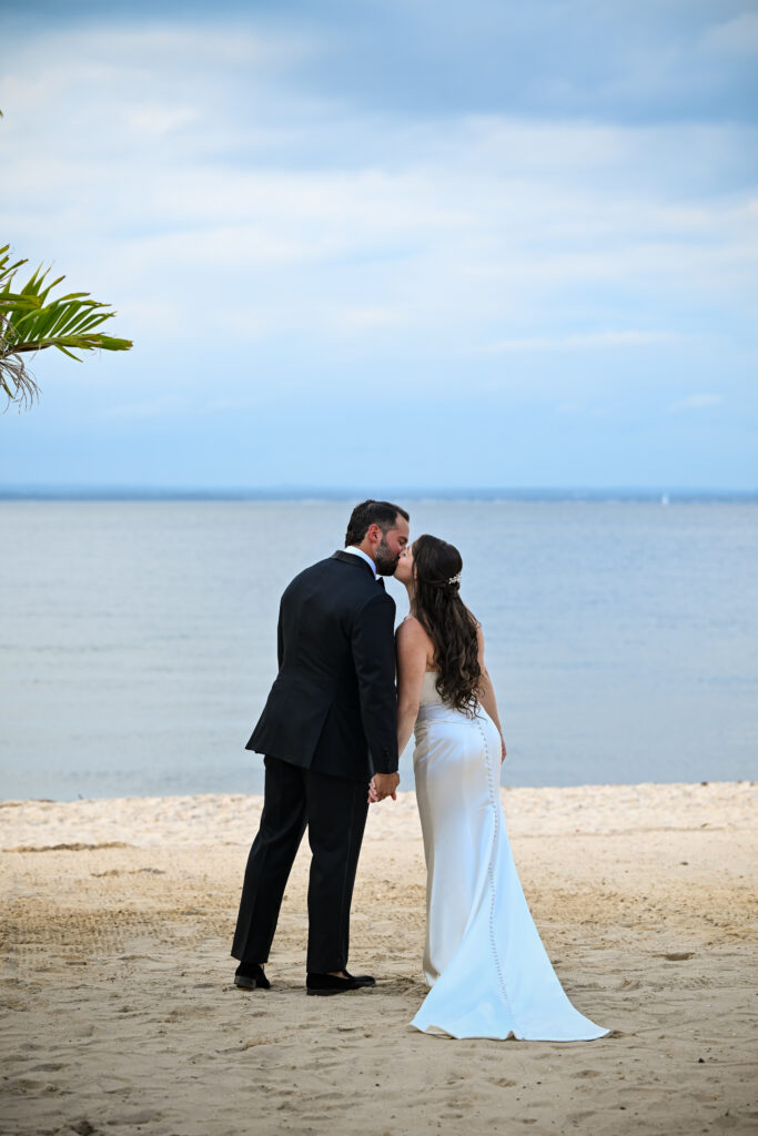 Wide beach wedding portrait at Crescent Beach Club, Long Island, New York with ocean and sky backdrop.