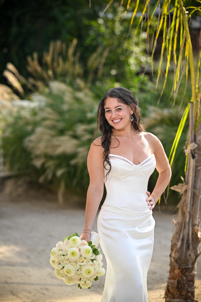 Bride portrait under palm trees at Crescent Beach Club on Long Island, New York.