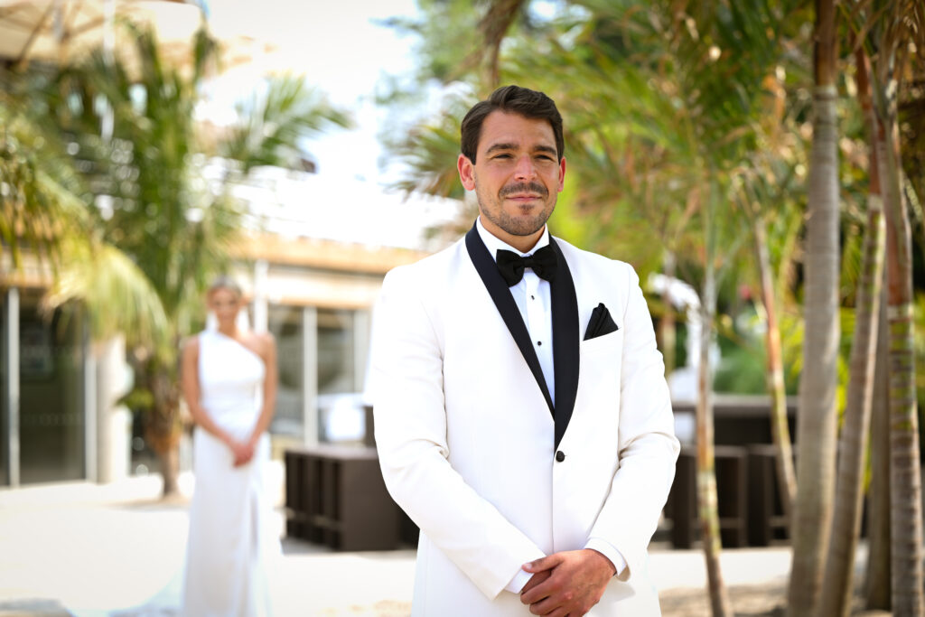 Groom portrait in white tuxedo jacket outdoors at Crescent Beach Club wedding on Long Island, New York.