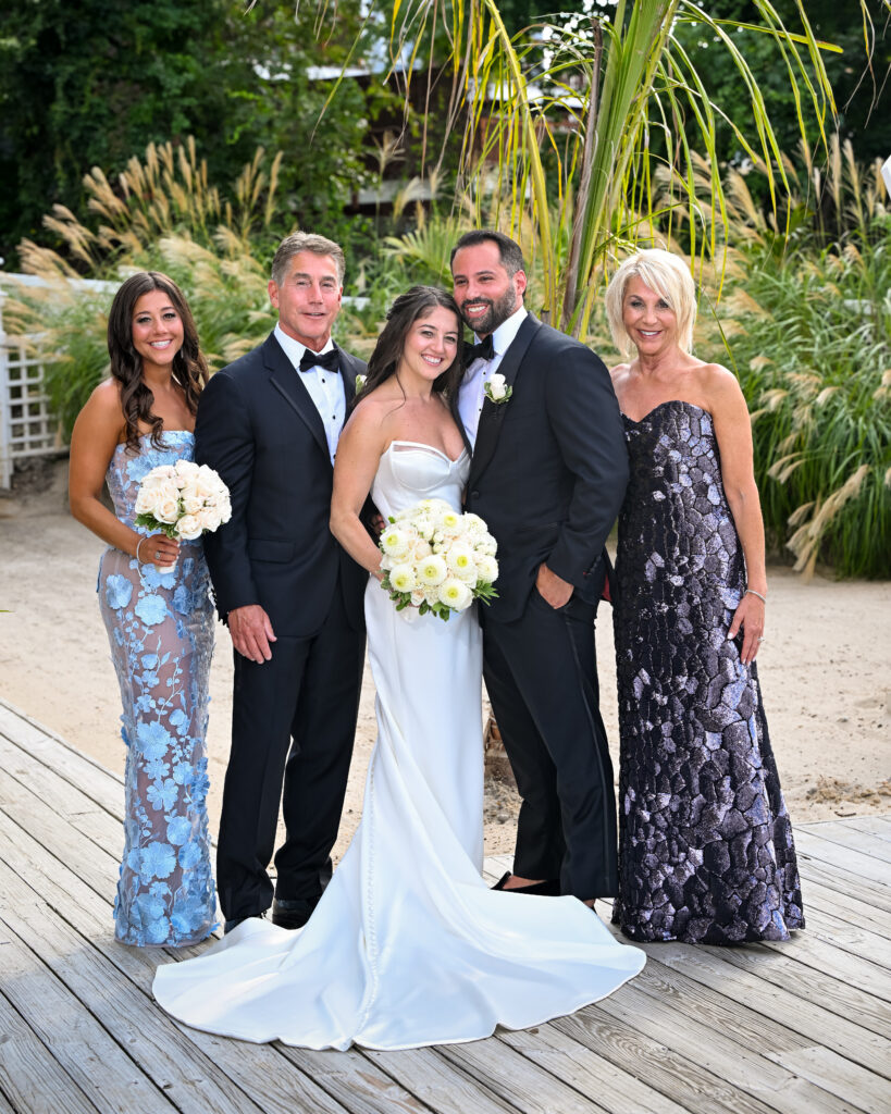 Wedding family group photo at Crescent Beach Club on Long Island, New York with beachside scenery.