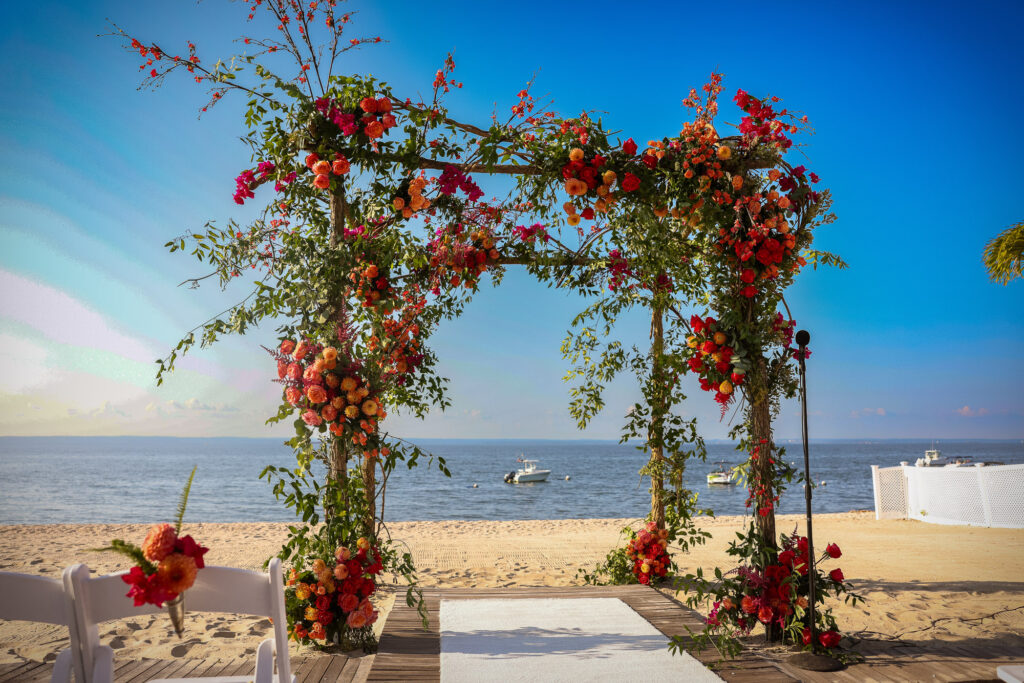 Crescent Beach Club wedding photo at Bayville, Long Island, New York: crescent beach club wedding ceremony floral arch ocean view. Photo by Doug Gordon | Patken Photographer.
