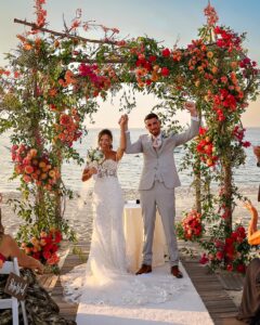 Crescent Beach Club wedding photo at Bayville, Long Island, New York: crescent beach club wedding recessional cheer under floral arch. Photo by Doug Gordon | Patken Photographer.
