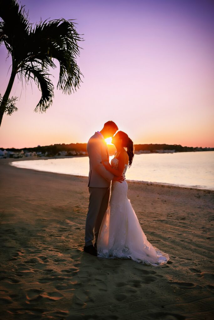 Crescent Beach Club wedding photo at Bayville, Long Island, New York: crescent beach club wedding sunset portrait kiss silhouette. Photo by Doug Gordon | Patken Photographer.