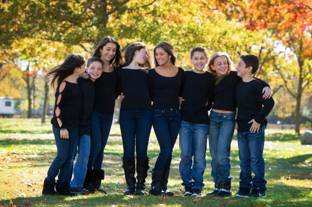 Fall family portrait captured in Muttontown, featuring autumn foliage, natural light, and a relaxed family moment.