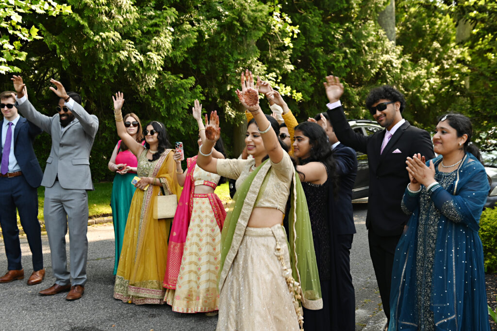 Indian wedding guests celebrating during baraat at Flowerfield St. James