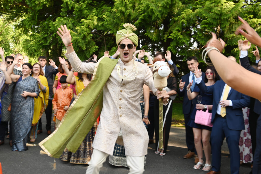 Groom dancing during baraat procession at Flowerfield Long Island wedding