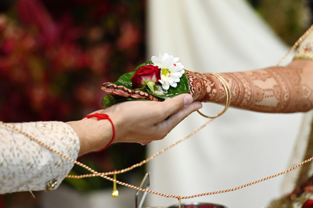 Close up of Indian wedding hands during sacred ritual ceremony