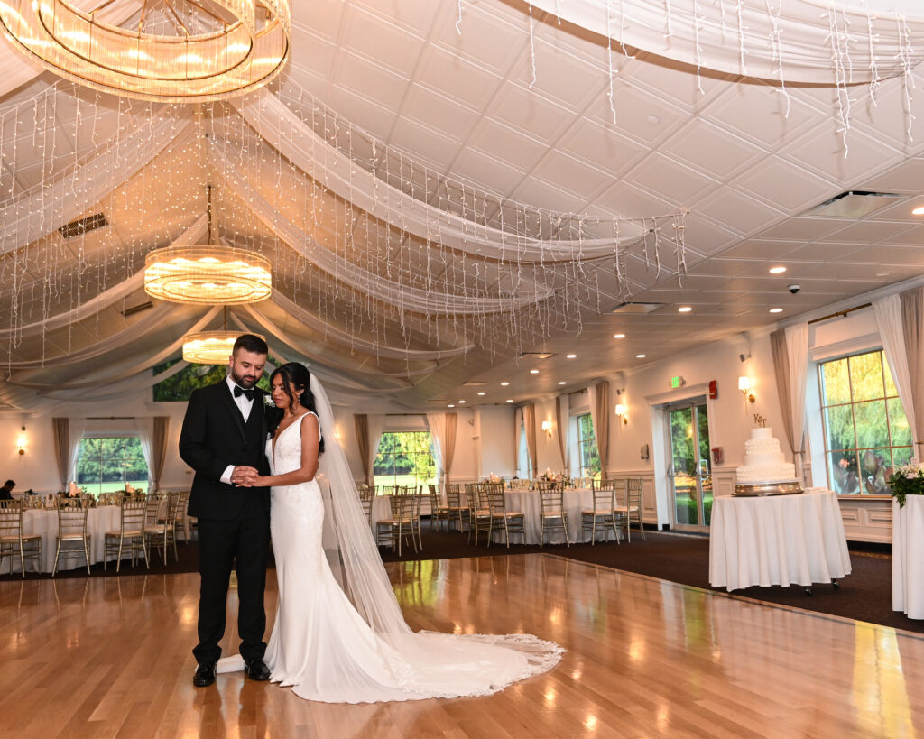Bride and groom first dance under draped ceiling at Flowerfield ballroom