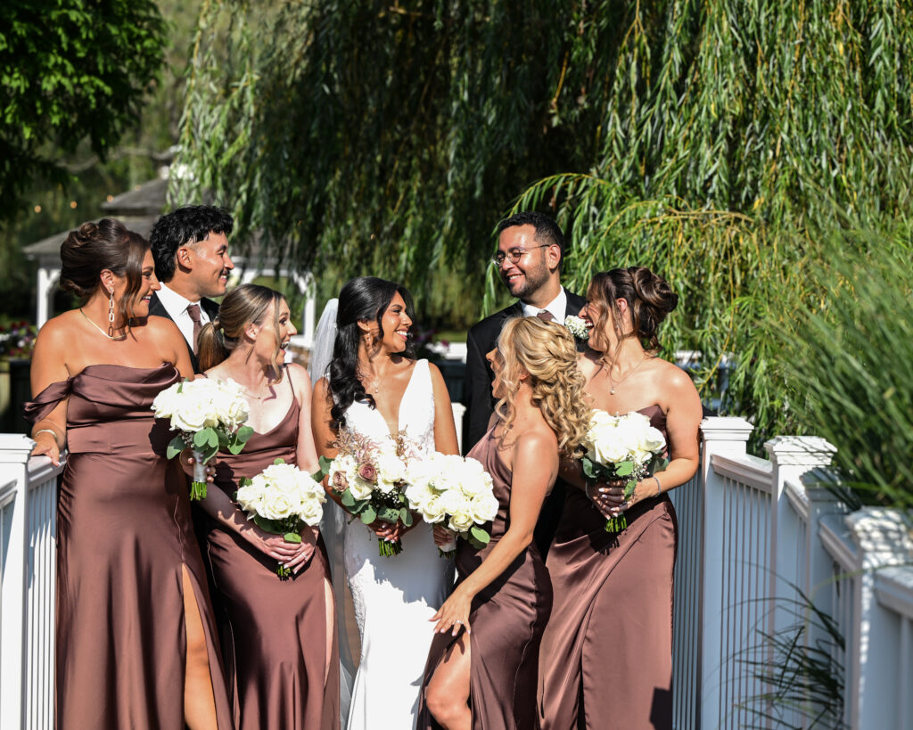 Bridesmaids and groom laughing on balcony at Flowerfield wedding