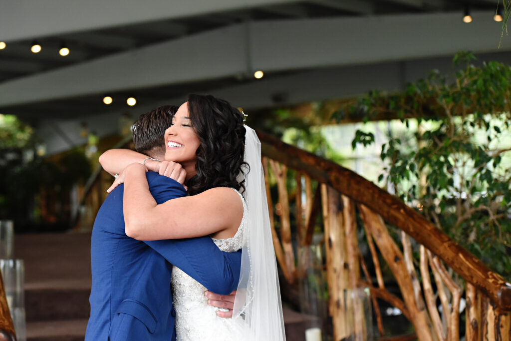 Emotional hug between bride and family member at Flowerfield wedding