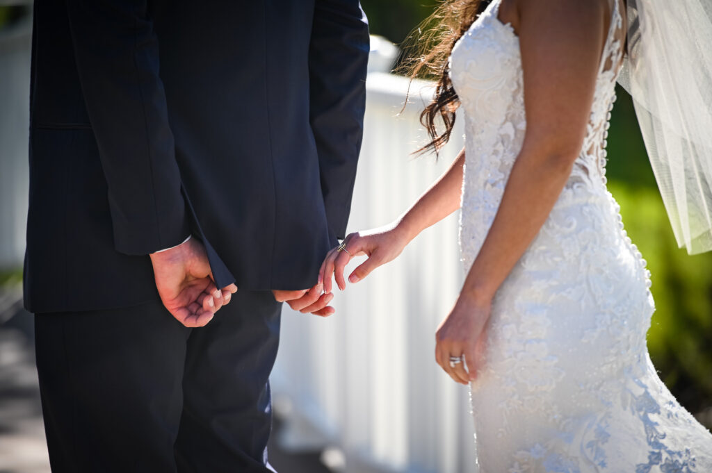 Close up of bride and groom holding hands at Flowerfield wedding