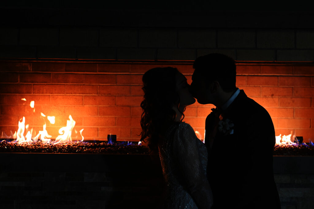 Romantic silhouette by fireplace at Flowerfield wedding venue