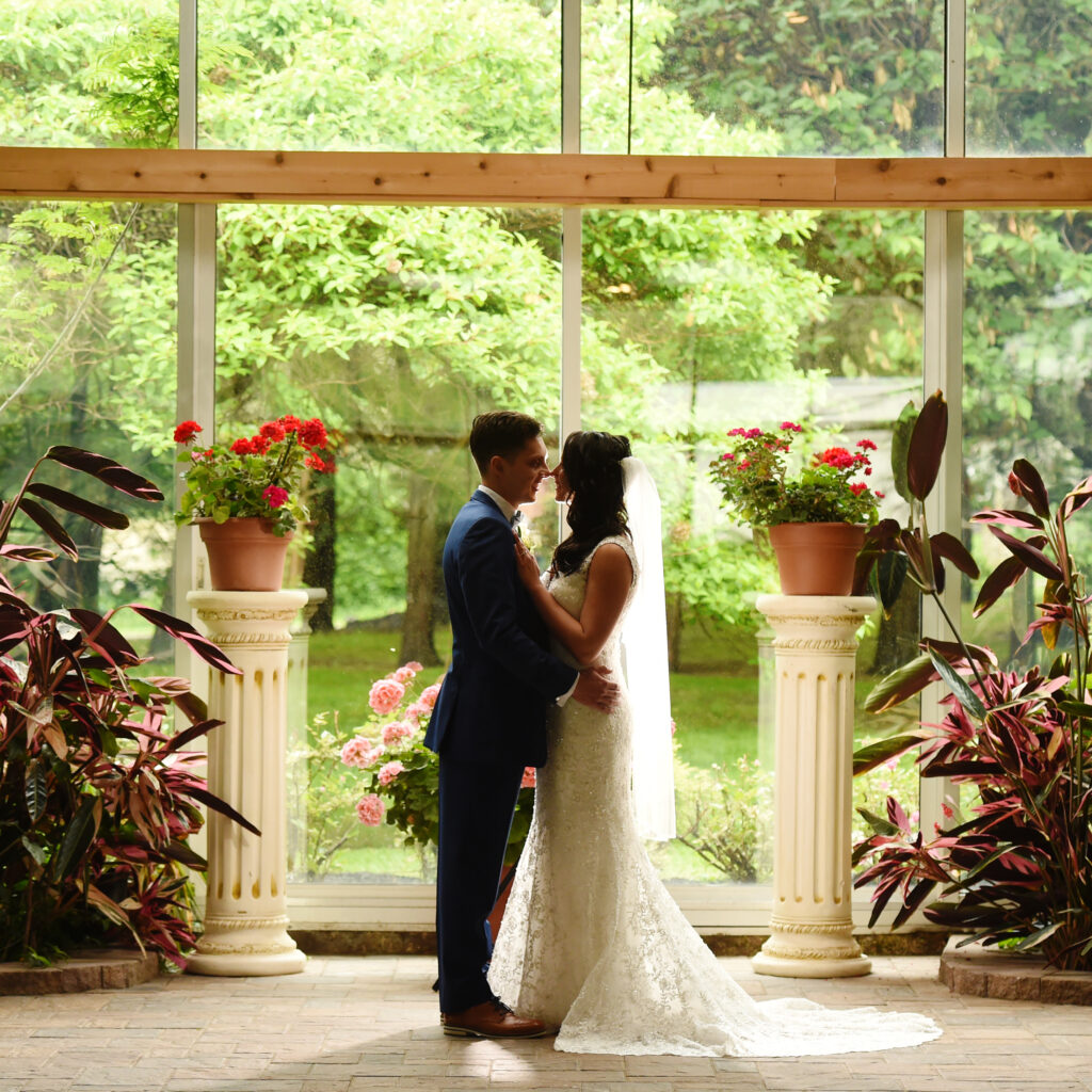 Bride and groom portrait framed by columns at Flowerfield