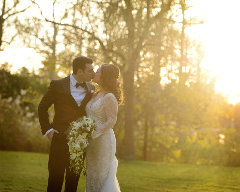 Golden hour portrait of couple in trees at Flowerfield wedding